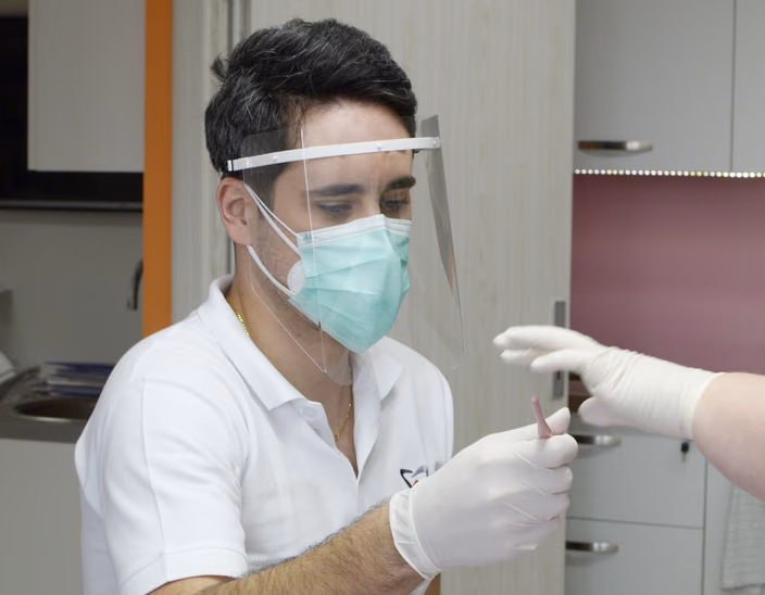 Dentist wearing a 3D-printed face shield with protective mask during the pandemic