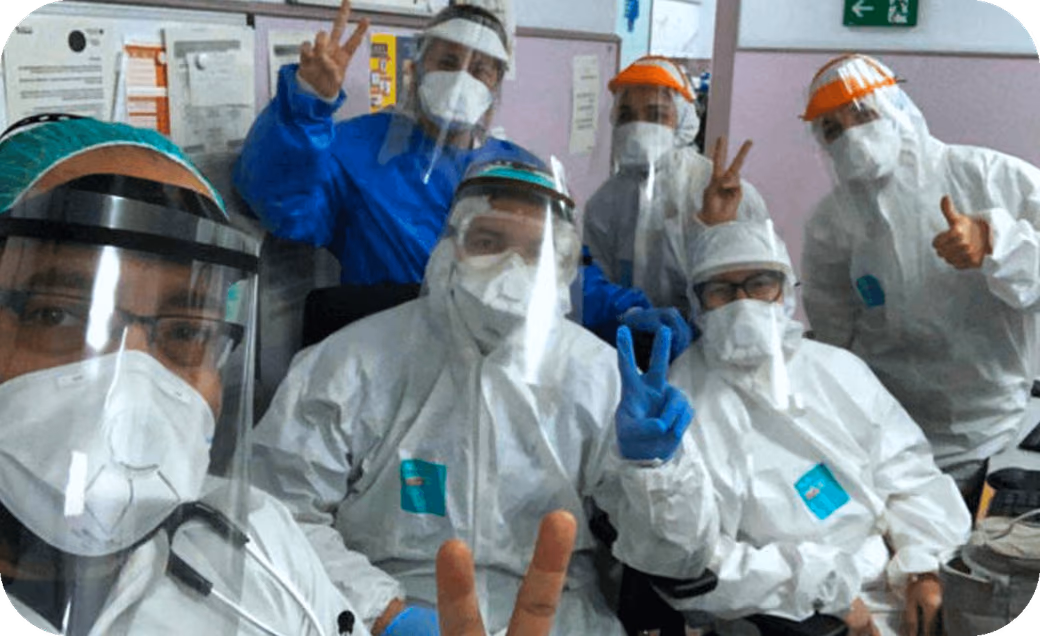 Healthcare workers in protective gear and face shields assembled during the COVID-19 pandemic response