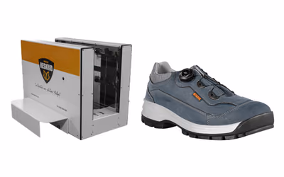 A Neskrid foot scanner next to a blue work shoe from Neskrid’s 2025 outdoor collection